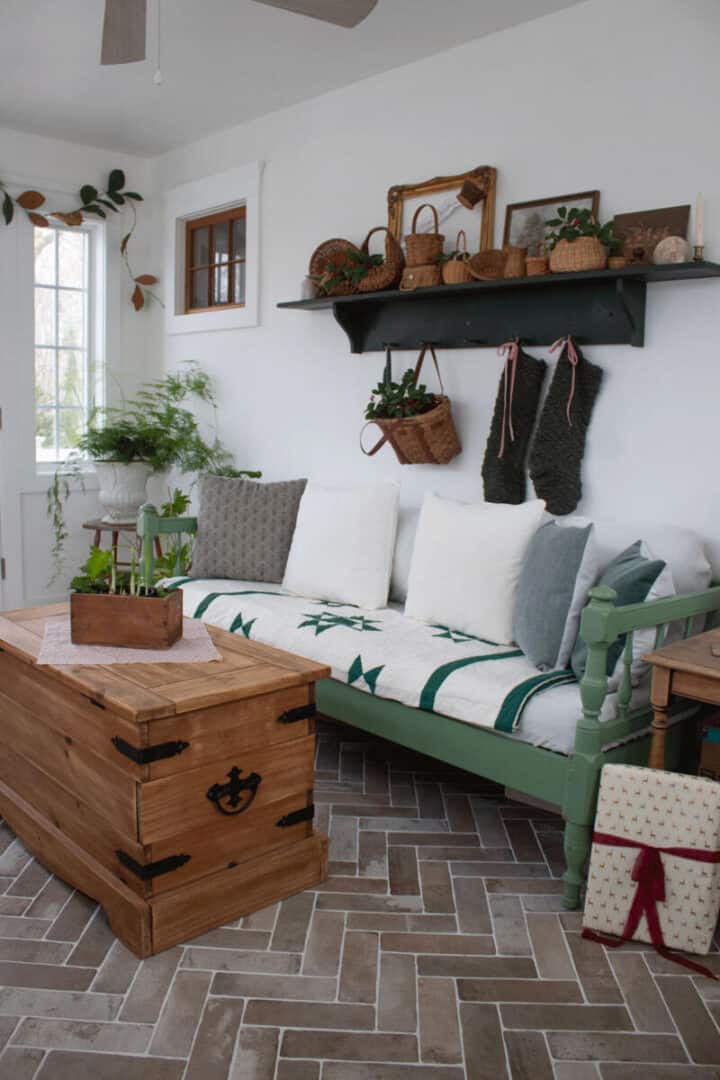 sunroom-sofa-with-green-and-white-vintage-cutter-quilt