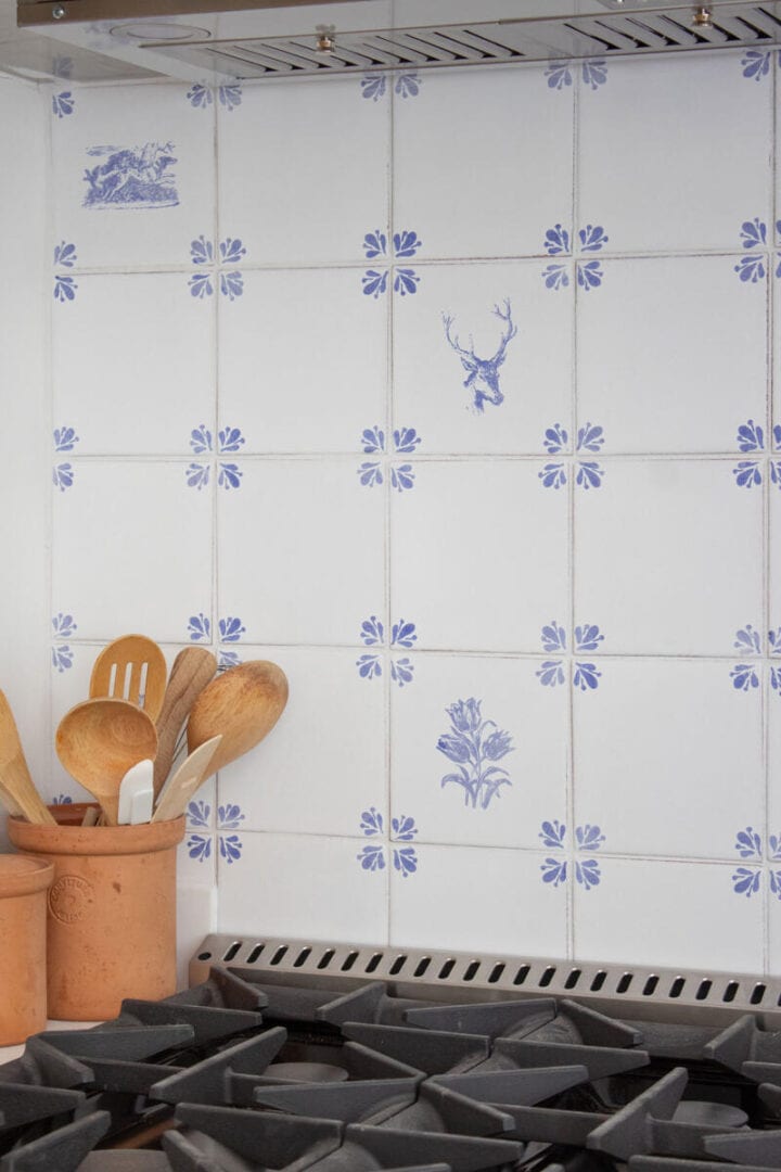 vintage-style-blue-and-white-tiles-kitchen - kitchen backsplash ideas accent tile over range