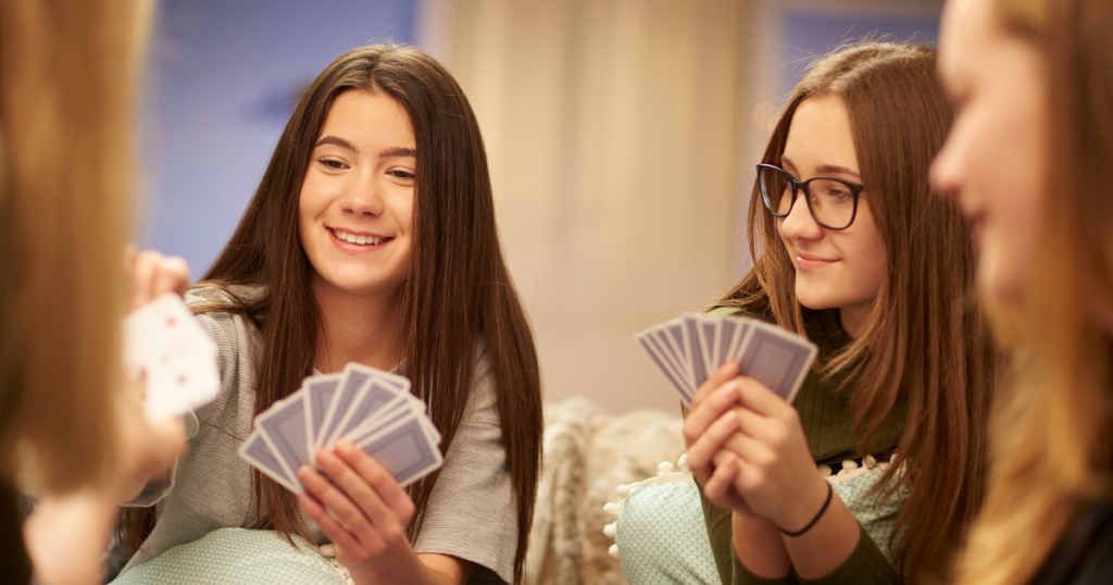 blog-post-pics-1024x538-3 girls playing a card game